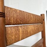 Brutalist style bed with chain and straw