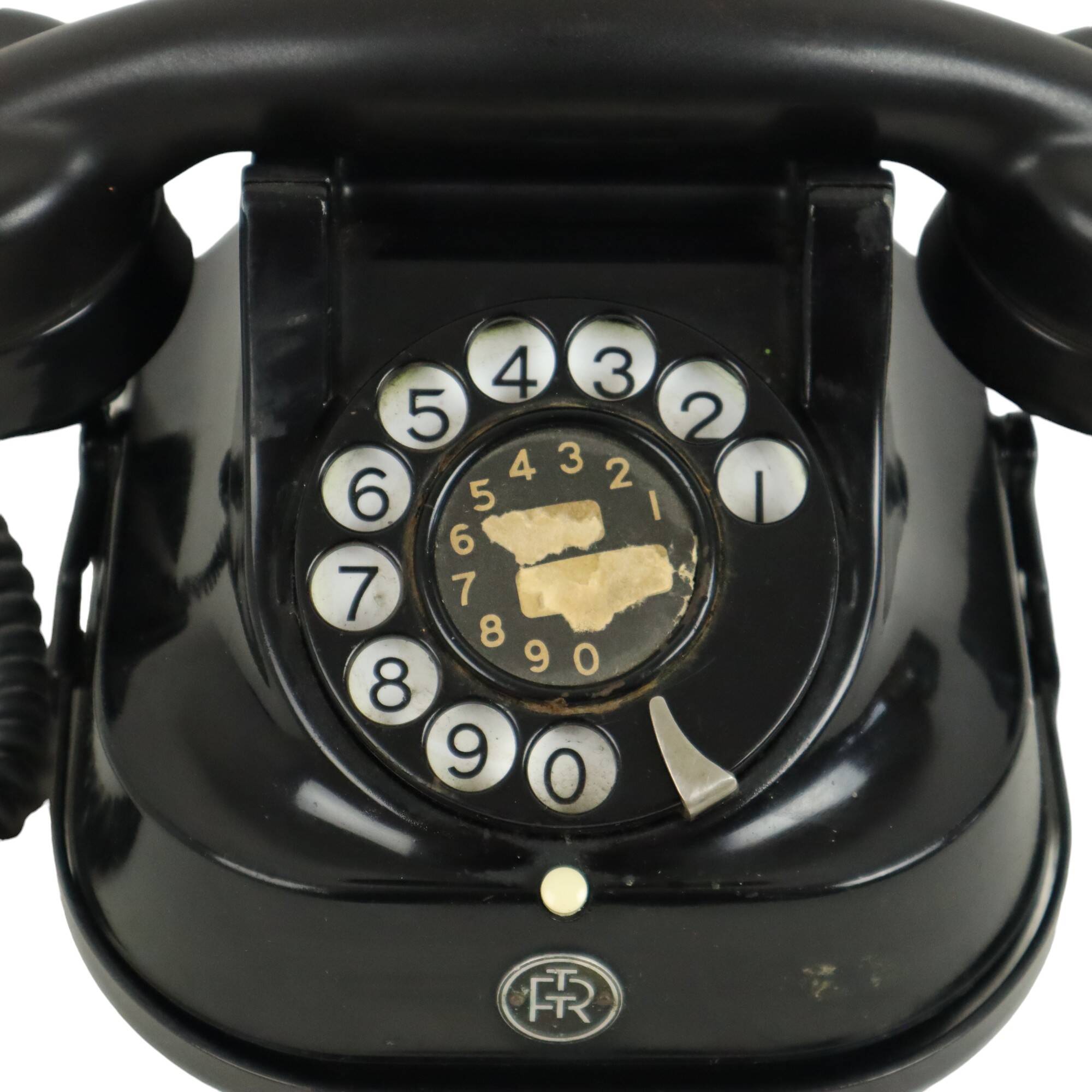 Old black telephone with rotary dial metal Bakelite RTT 56B