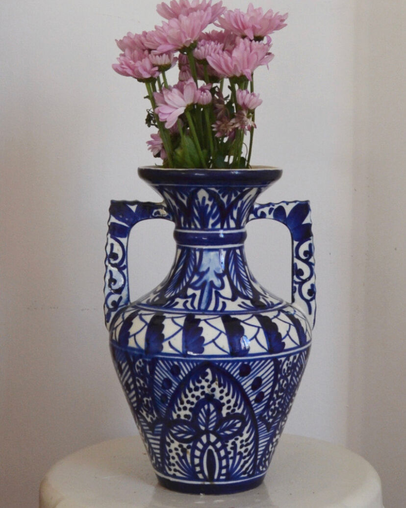 White hand-painted ceramic vase with blue patterns