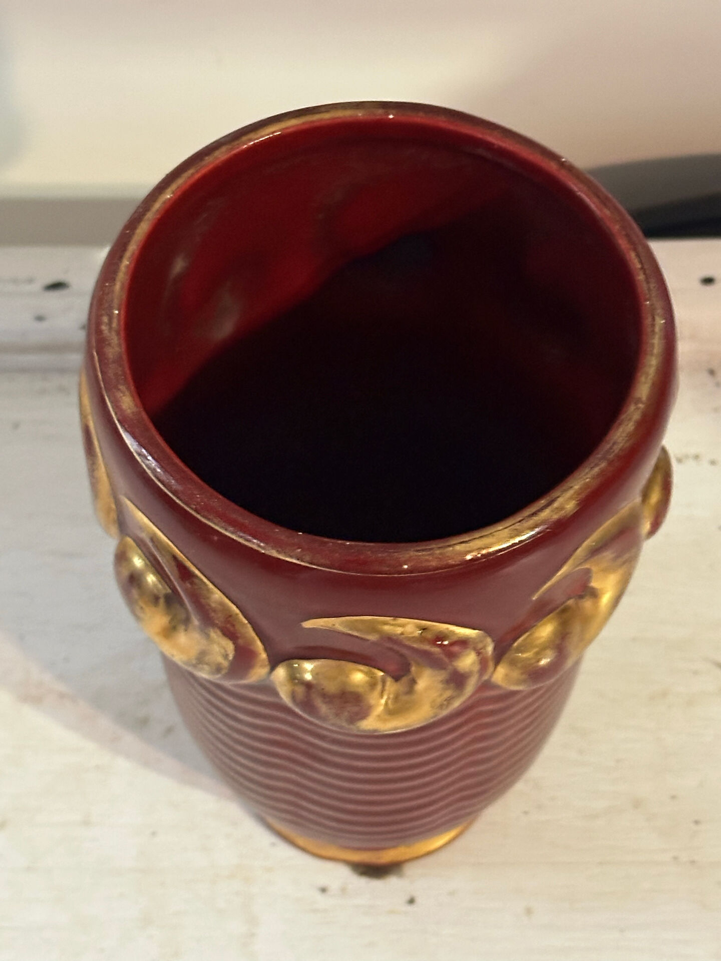 Mid-century relief vase in ruby red enhanced with gilding.