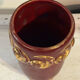 Mid-century relief vase in ruby red enhanced with gilding.