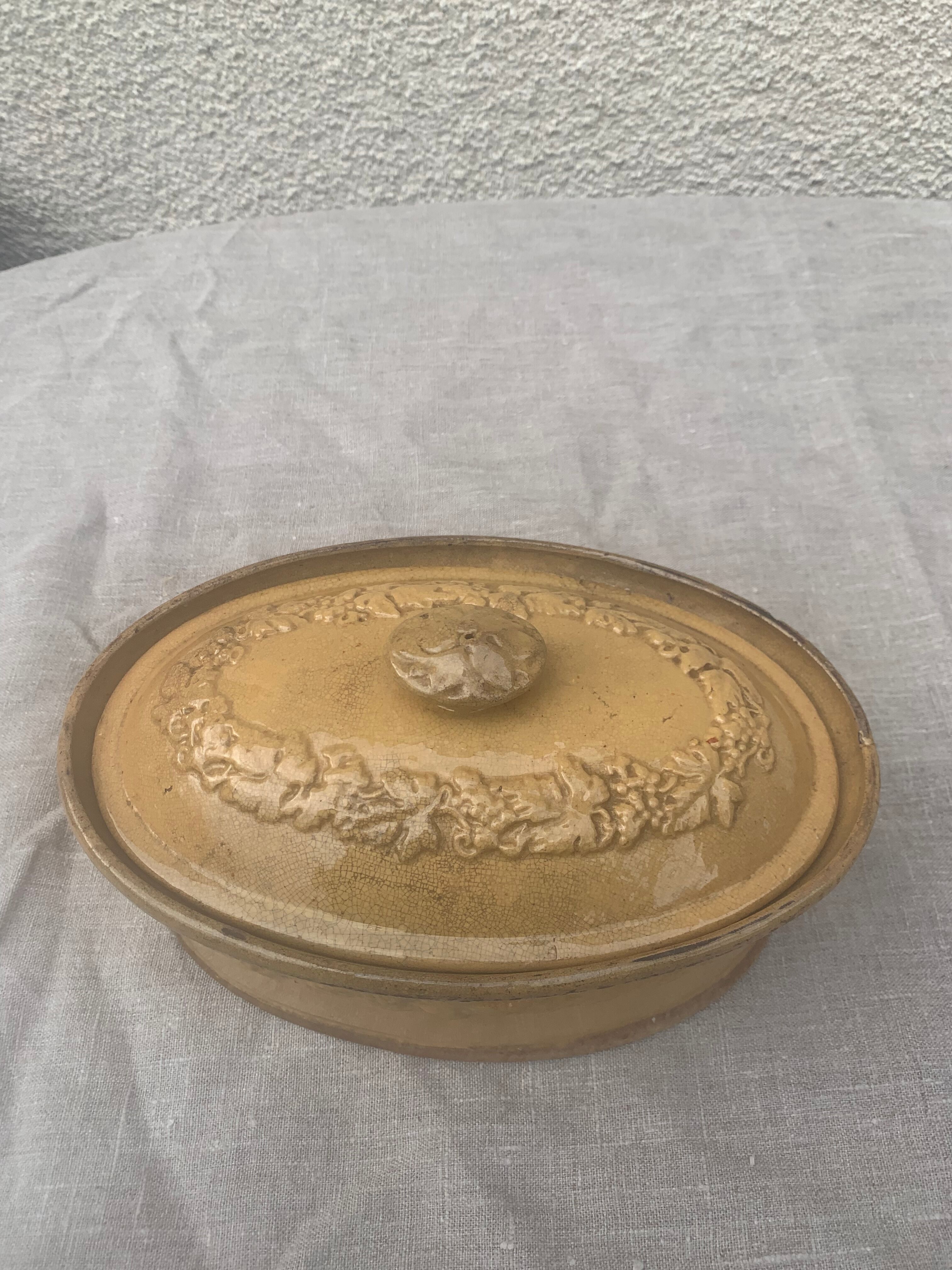Old terrine in glazed stoneware and floral decoration mustard yellow slip