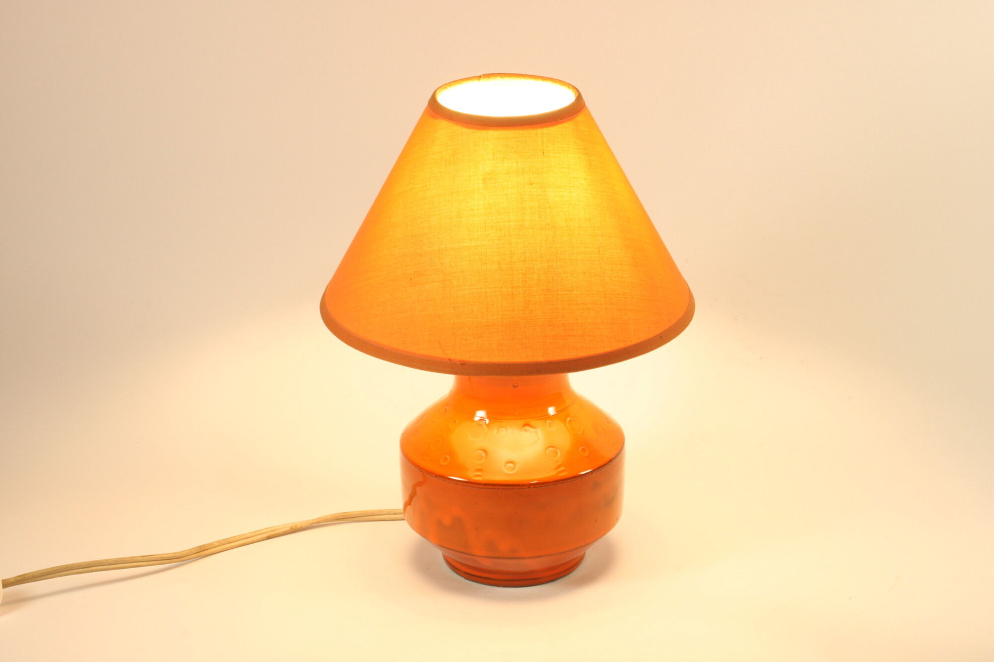 Orange ceramic table lamp with geometric imprints, 1970s.