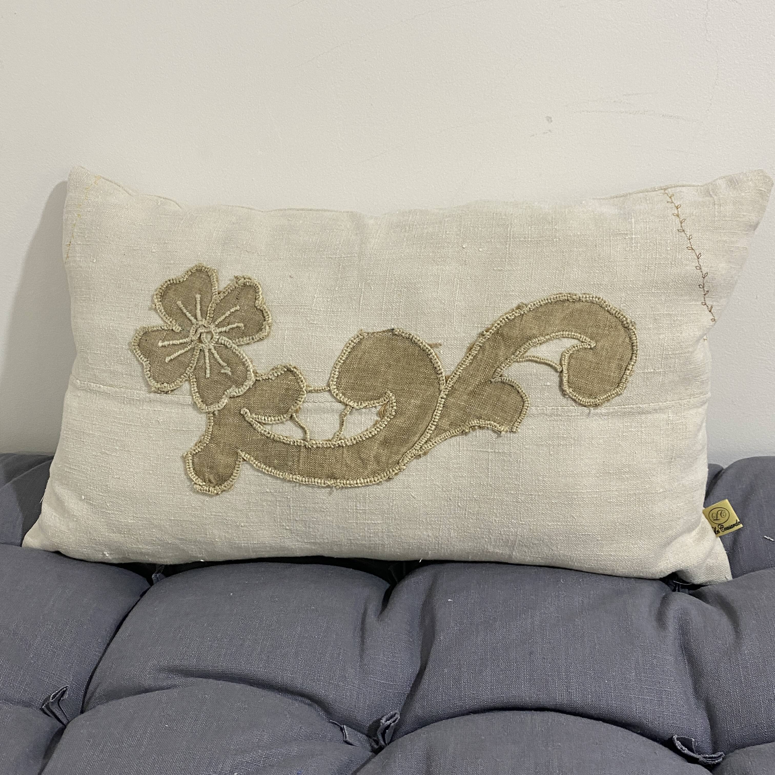 Cushion in vintage fabric with ornamentation