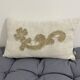 Cushion in vintage fabric with ornamentation.
