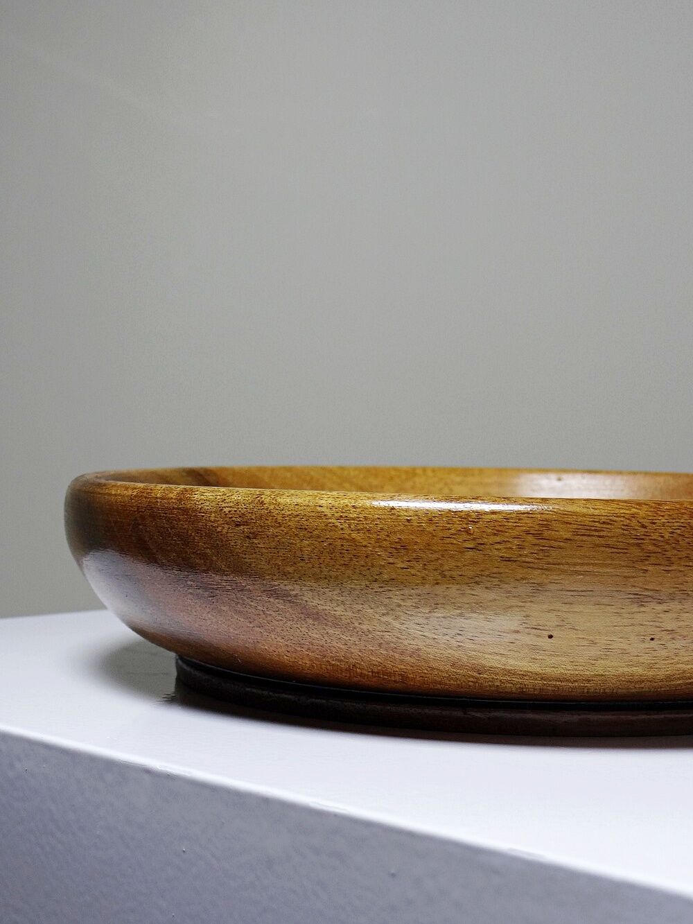 Teak or acacia wood bowl, vintage craftsmanship from the 70s to 2000s.