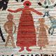 Vintage handwoven tapestry with a folk scene and archaic Slavic writing.