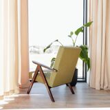 Vintage armchair in moss green bouclé design by H. Lis.