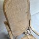 Rocking chair with a cane seat and backrest.