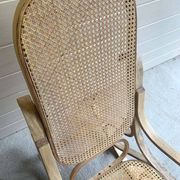 Rocking chair with a cane seat and backrest.