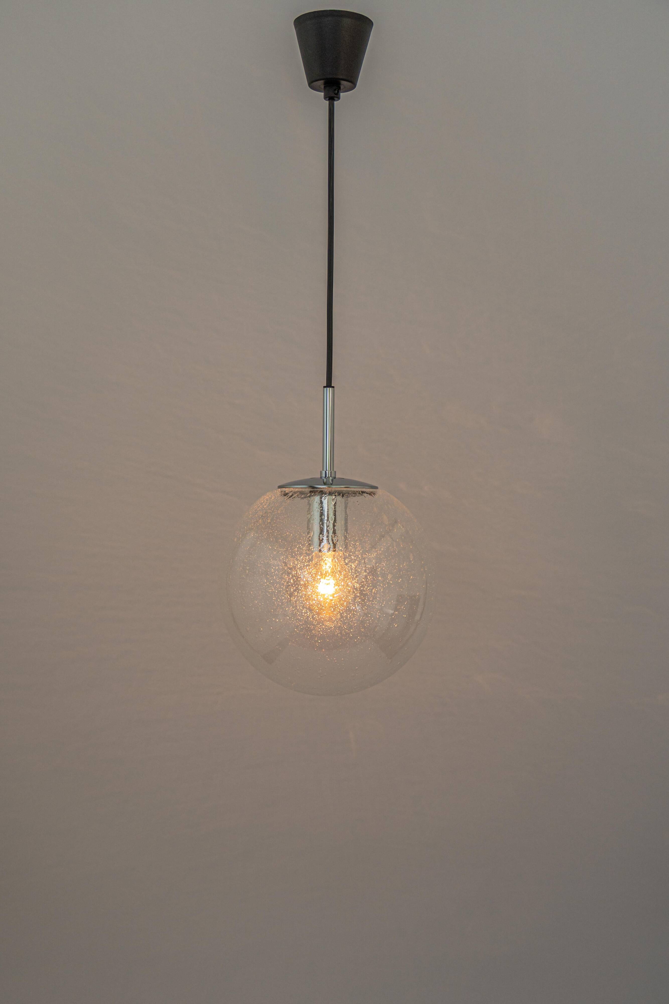 Small Limburg chrome pendant light with clear glass globe, Germany, 1970s.