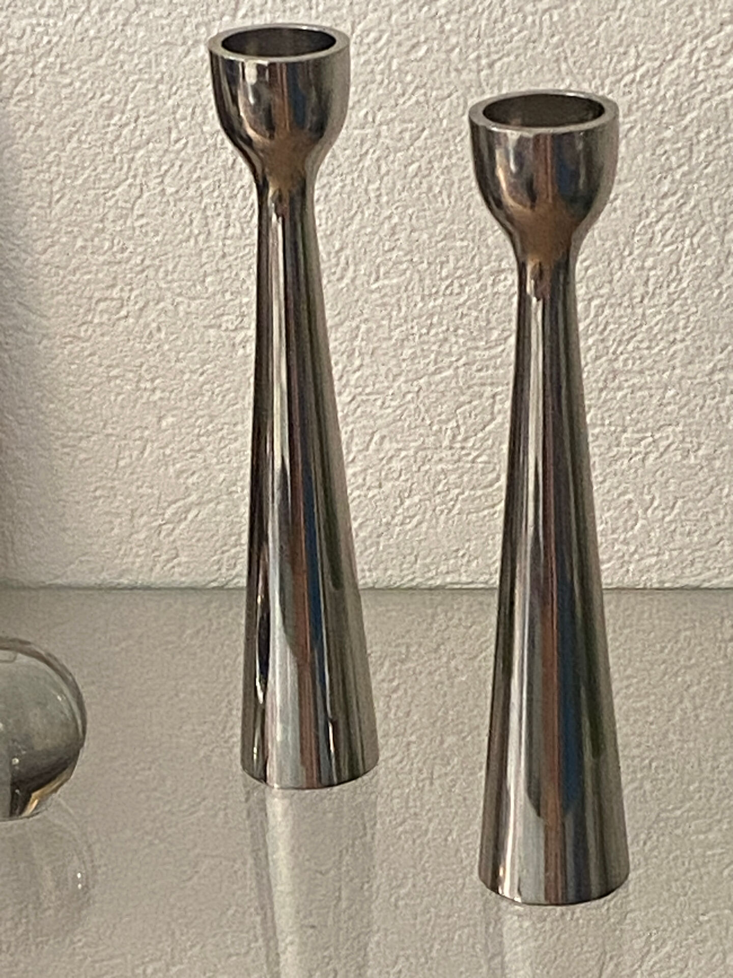 Pair of polished aluminium candlesticks