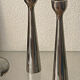 Pair of polished aluminium candlesticks