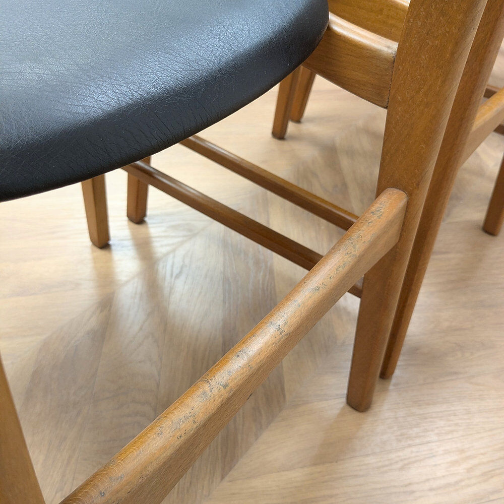 Set of 4 Danish chairs in teak and black faux leather, 1960s.