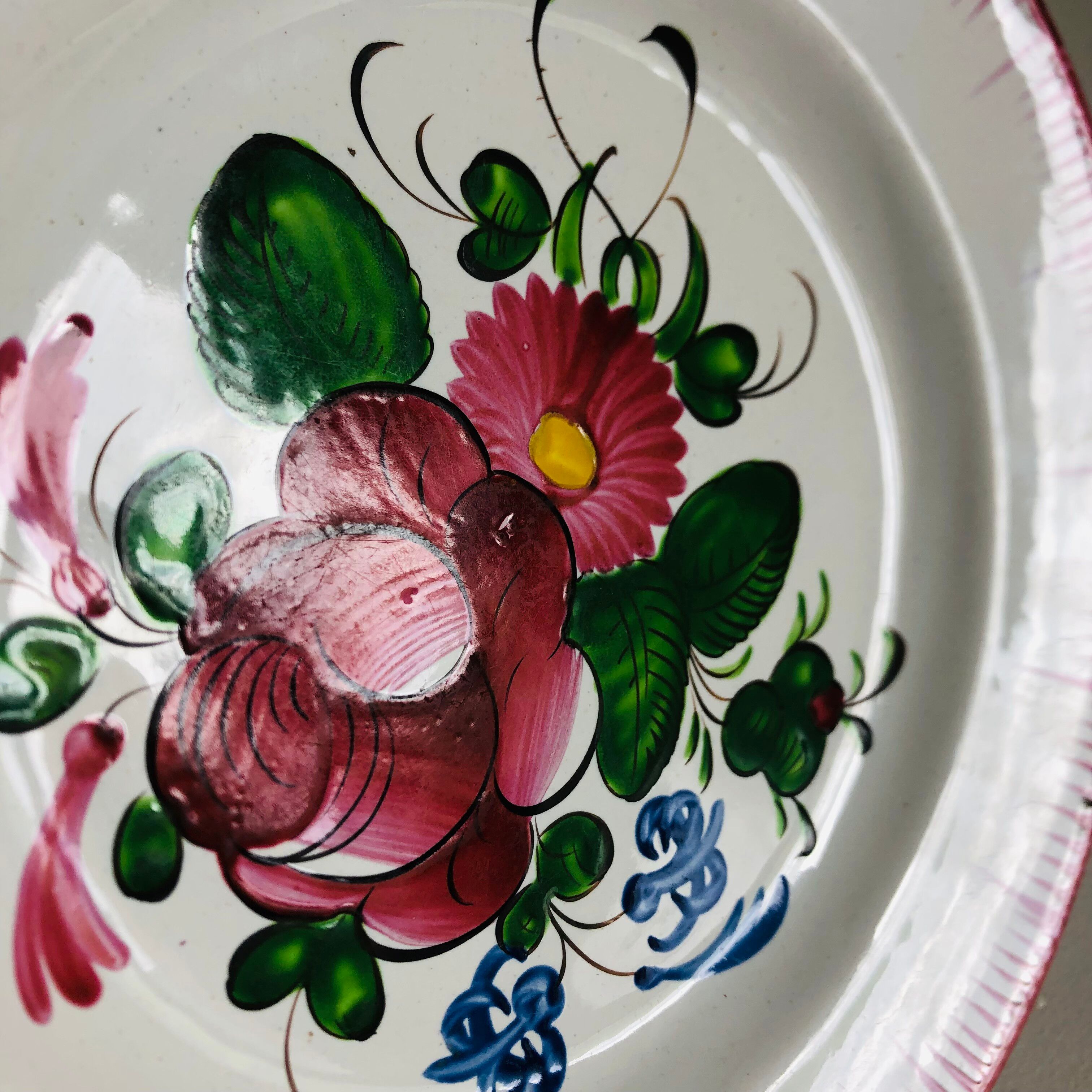 Eastern earthenware plate from the mid-19th century with a hollow rose design.