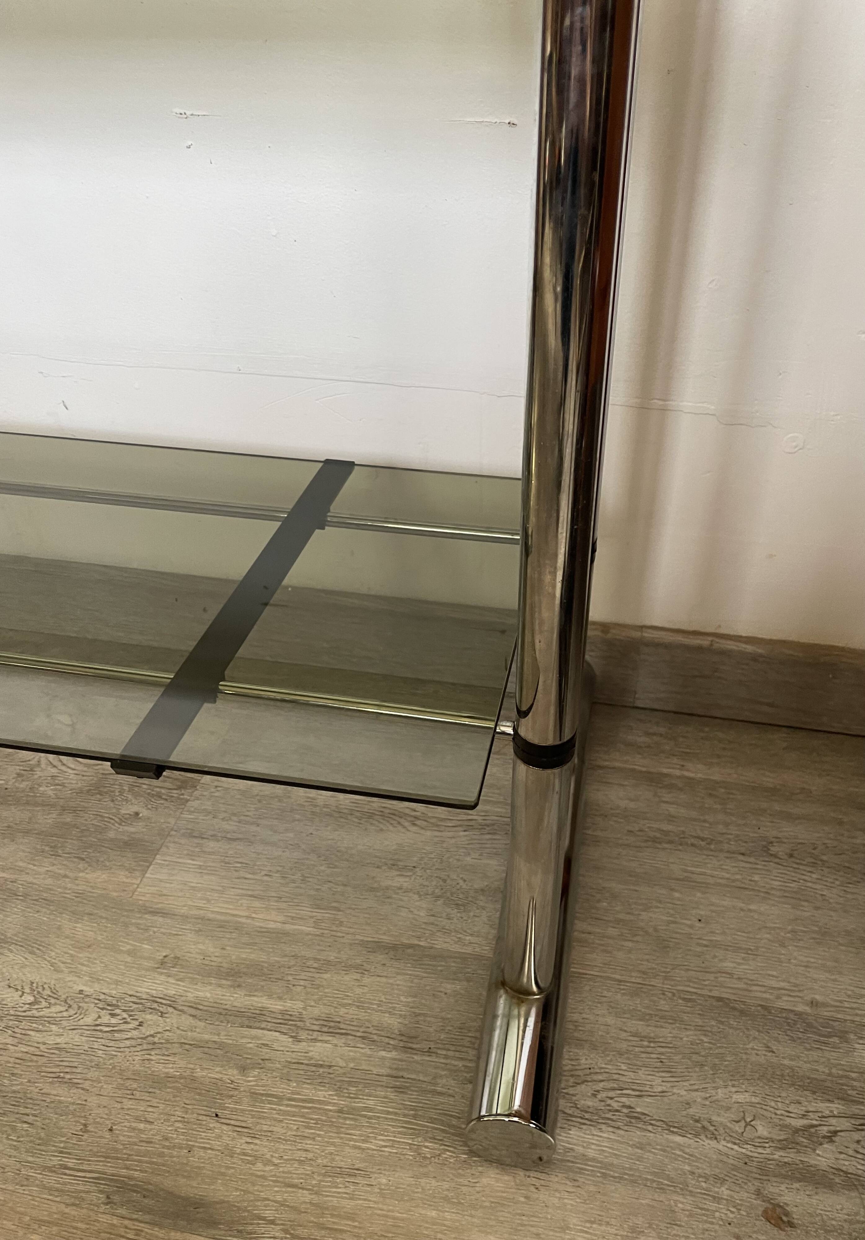 Chromed metal tubular shelf with smoked glass.