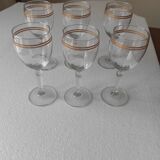 Set of 6 glasses with gold band decorations.