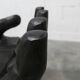 Black armchair chair in carved wood in the shape of a hand