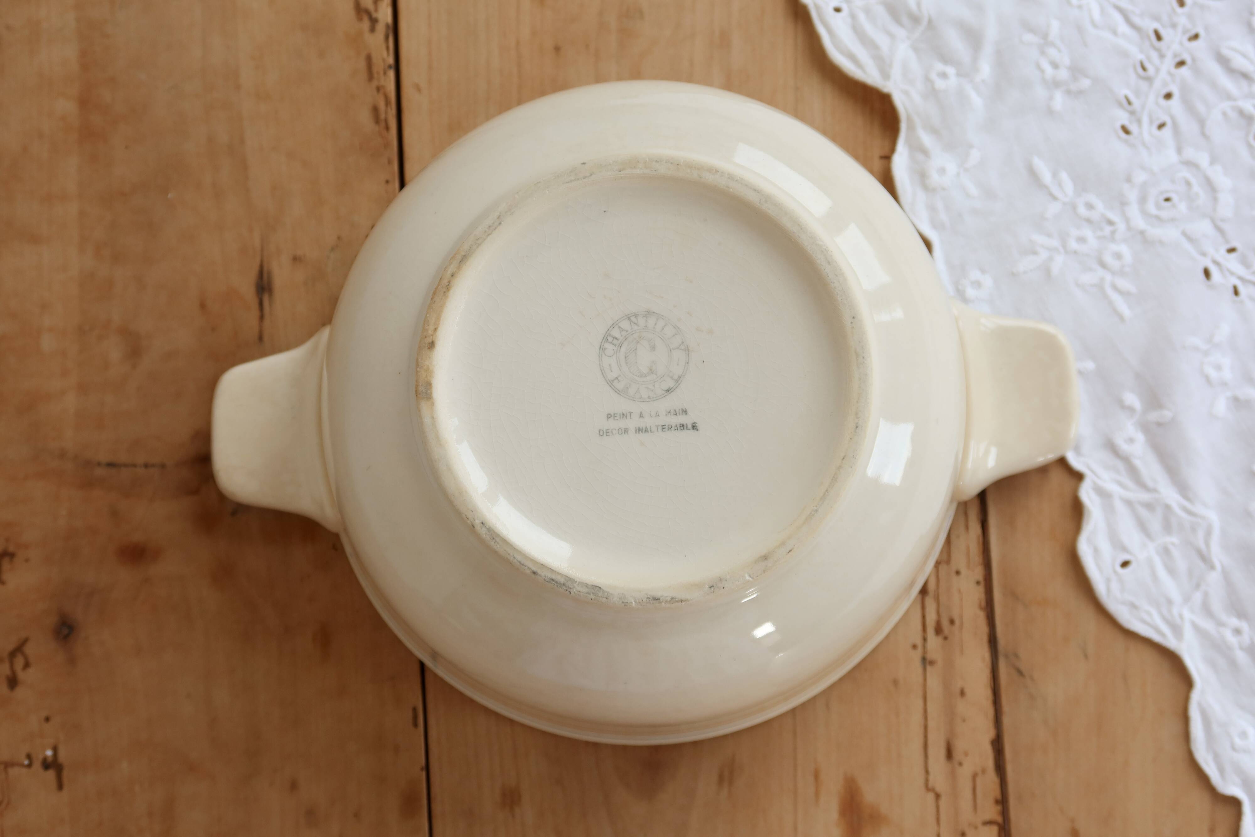 Vintage salad bowl in ivory faience from Chantilly with a rainbow trim.