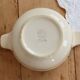 Vintage salad bowl in ivory faience from Chantilly with a rainbow trim.