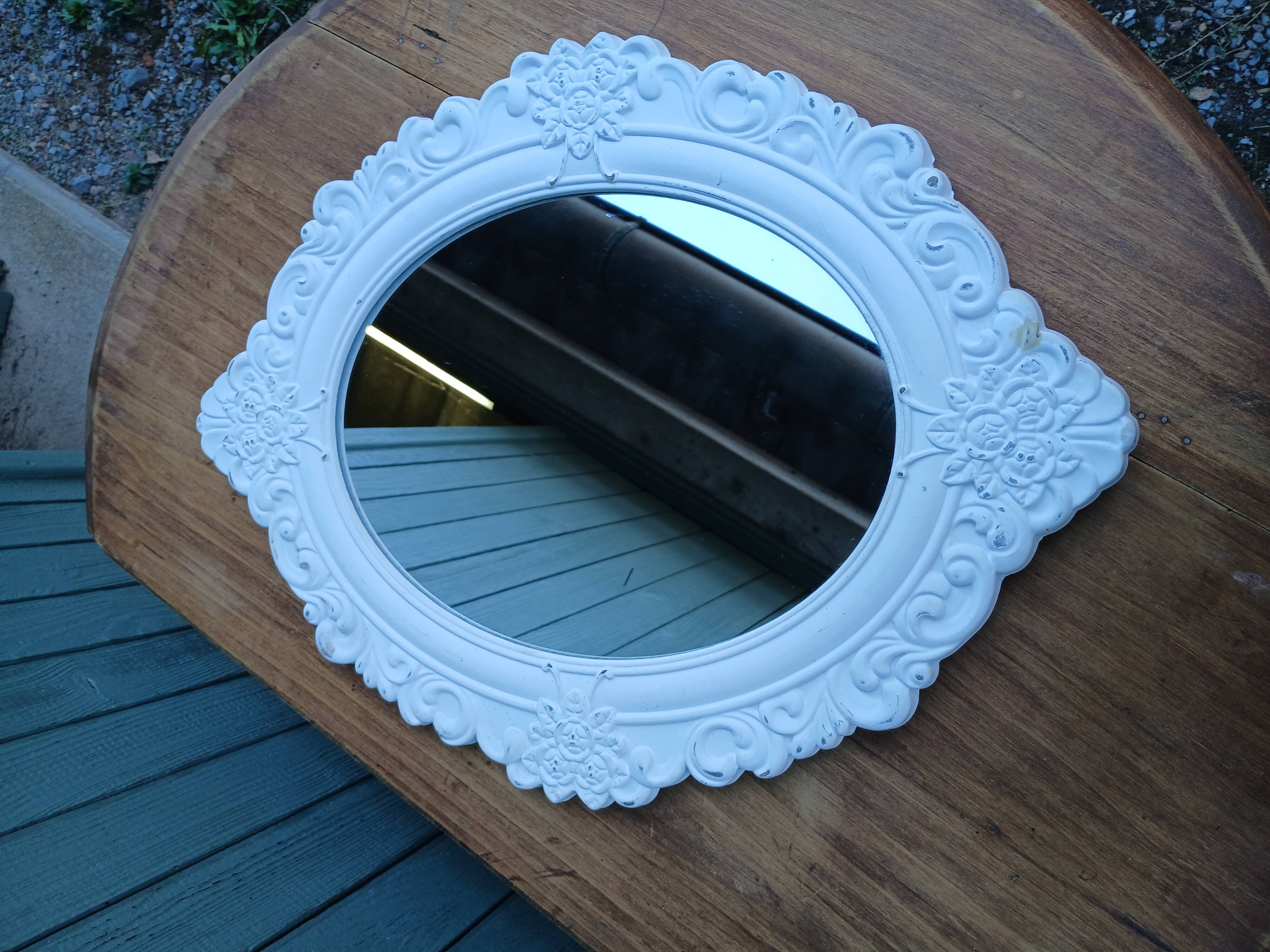 Oval mirror with white frame