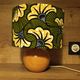 Solid wood ball lamp, lampshade with stylised wax flowers in khaki/yellow.