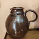 Set of three vintage ceramic jugs and a pitcher.