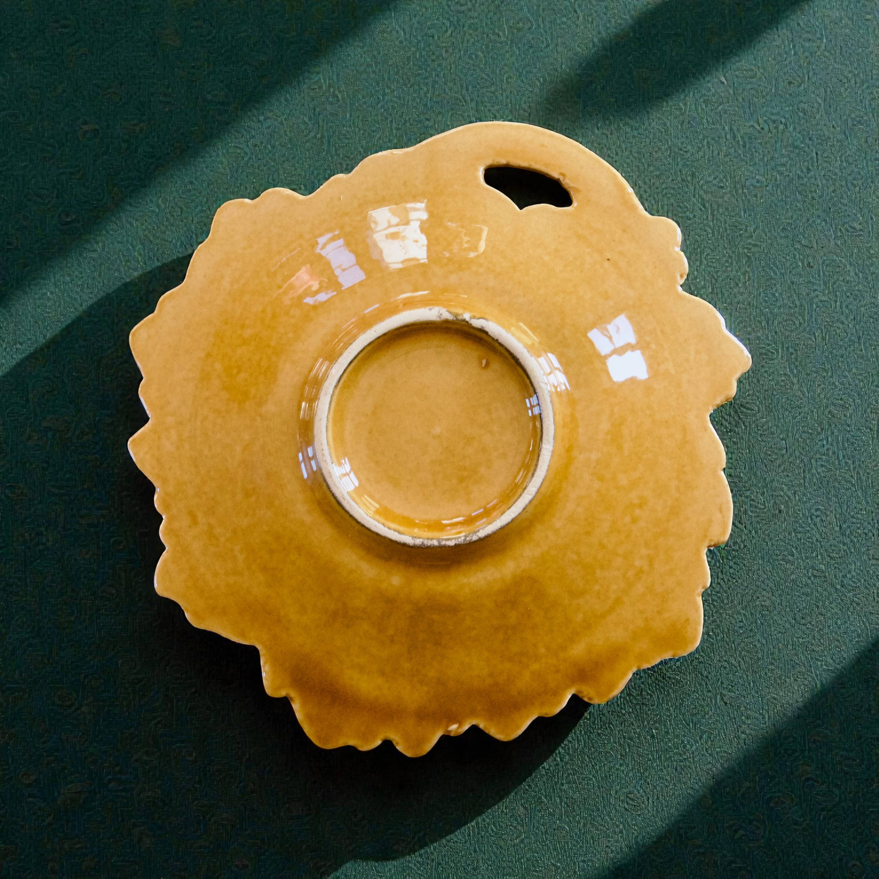 Vintage soap dish in ochre faience, leaf shape.