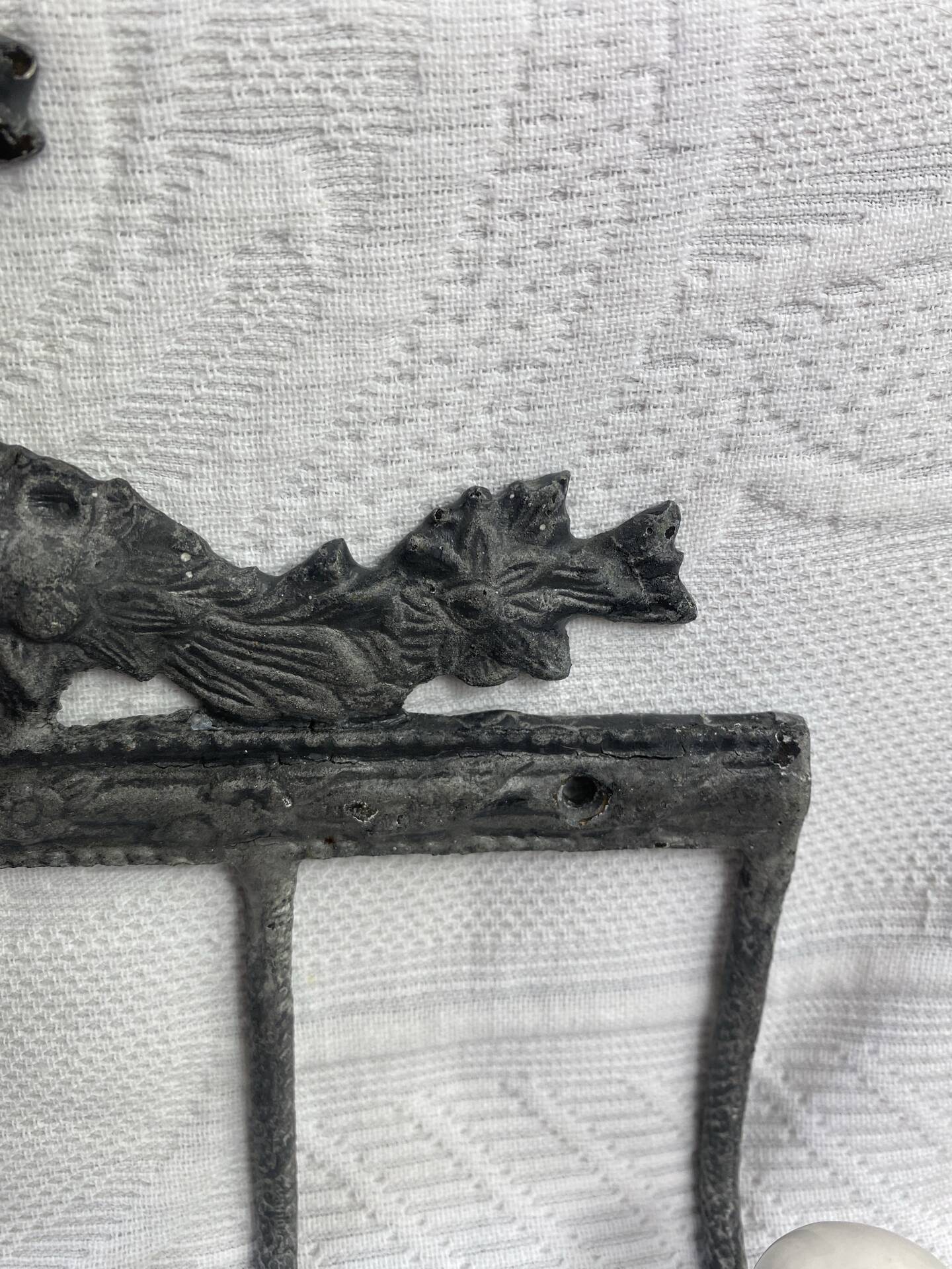 Patinated metal wall bracket and porcelain