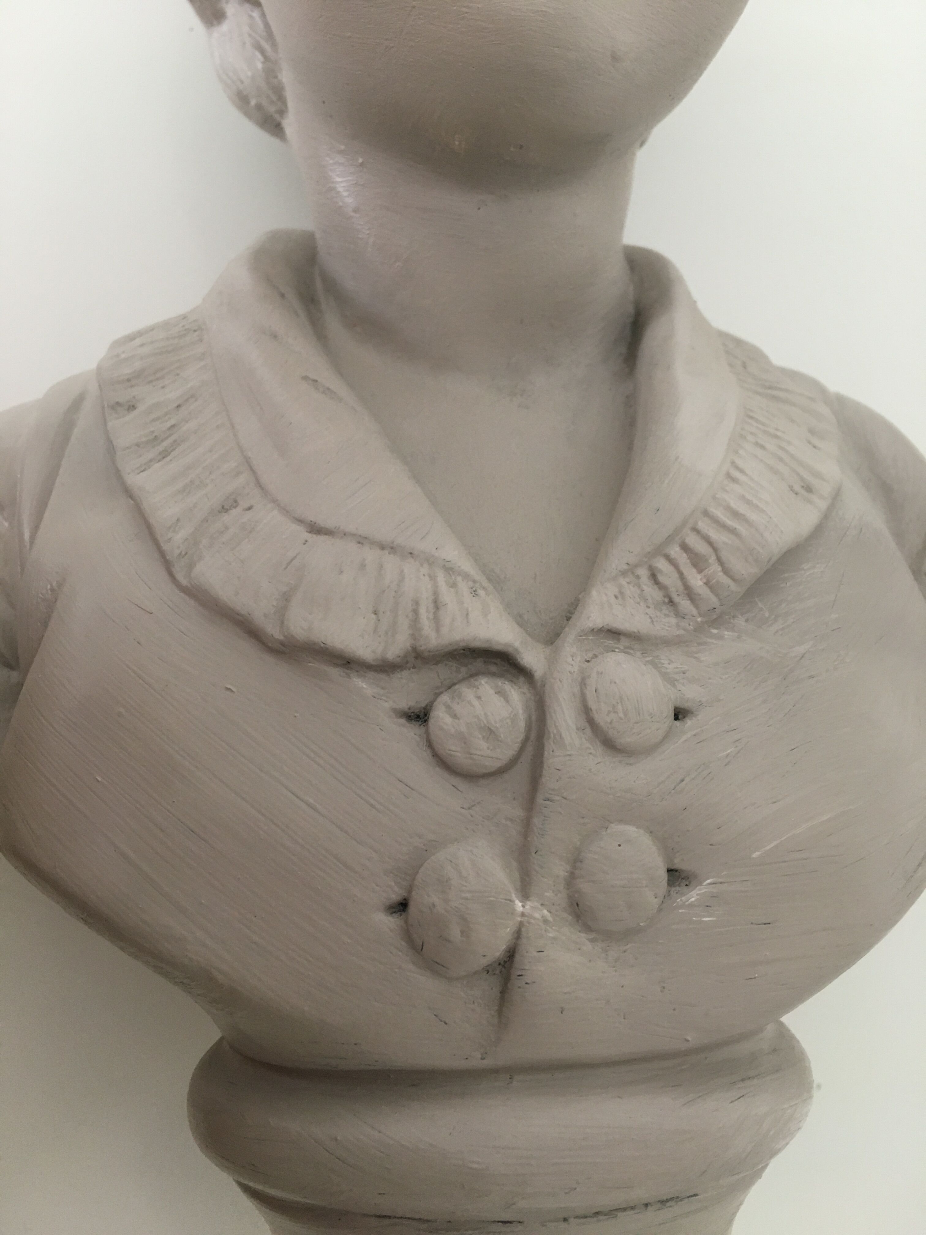 Cherub bust in platter