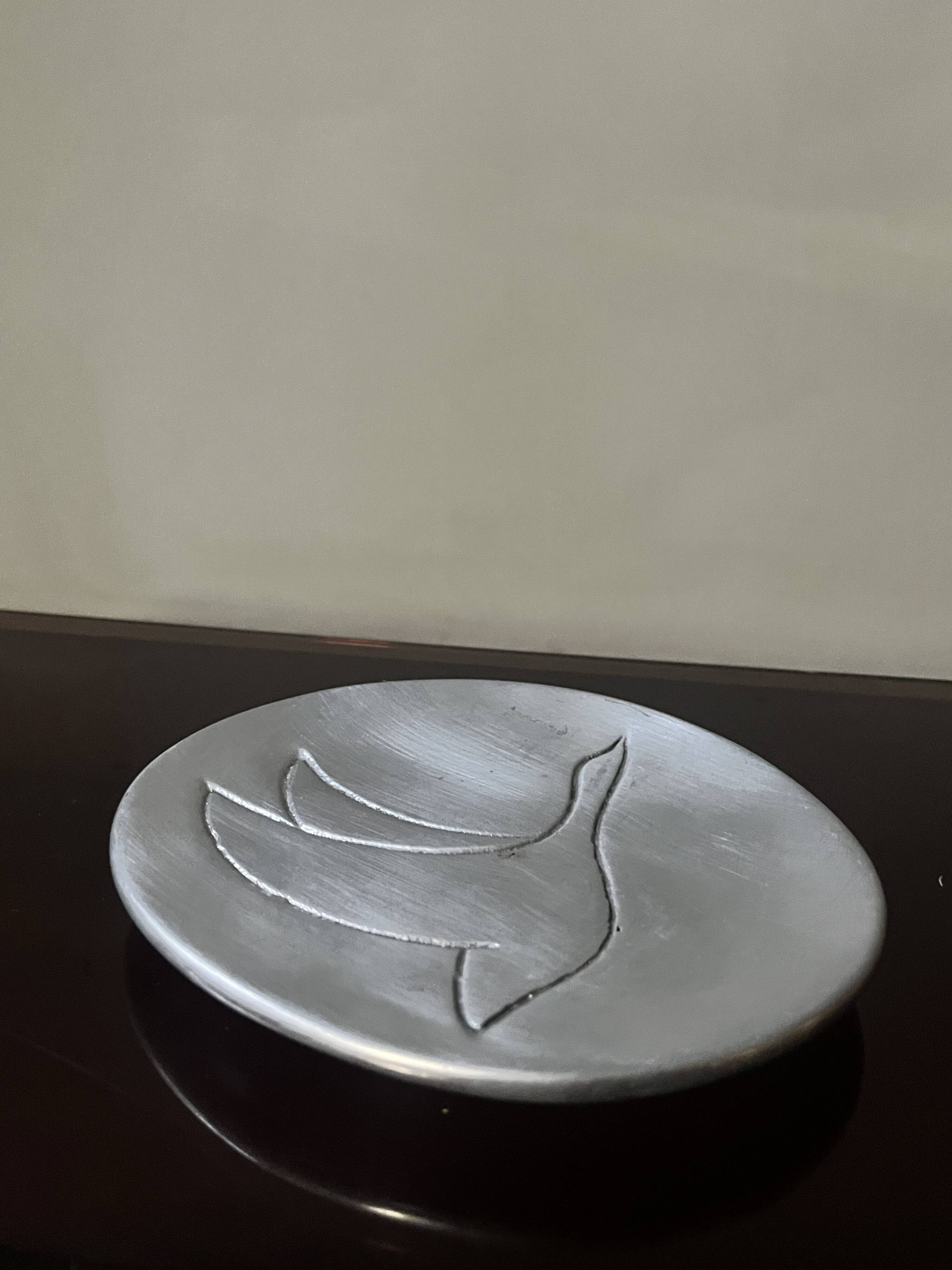 polished aluminum pocket emptier, signed and stamped in the mass