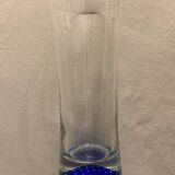 Glass roller vase with blue bubble background