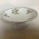 Old footed dish with gypsophila, white flowers.