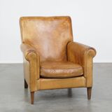 Stylish patinated vintage sheepskin armchair with a comfortable seat