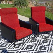 Pair of vintage armchairs in black faux leather and red fabric.
