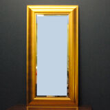 Large mirror in a golden decorative frame