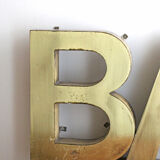 Old brass sign letters, word BAR