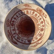 Large shallow terracotta dish decorated with birds, 20th century.