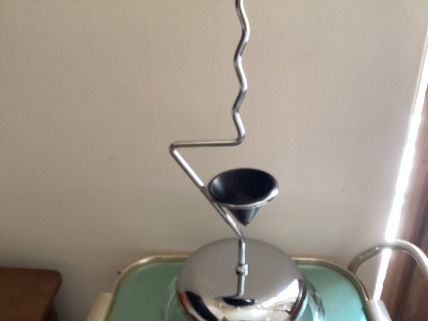 Designer umbrella stand in chrome metal and wood.