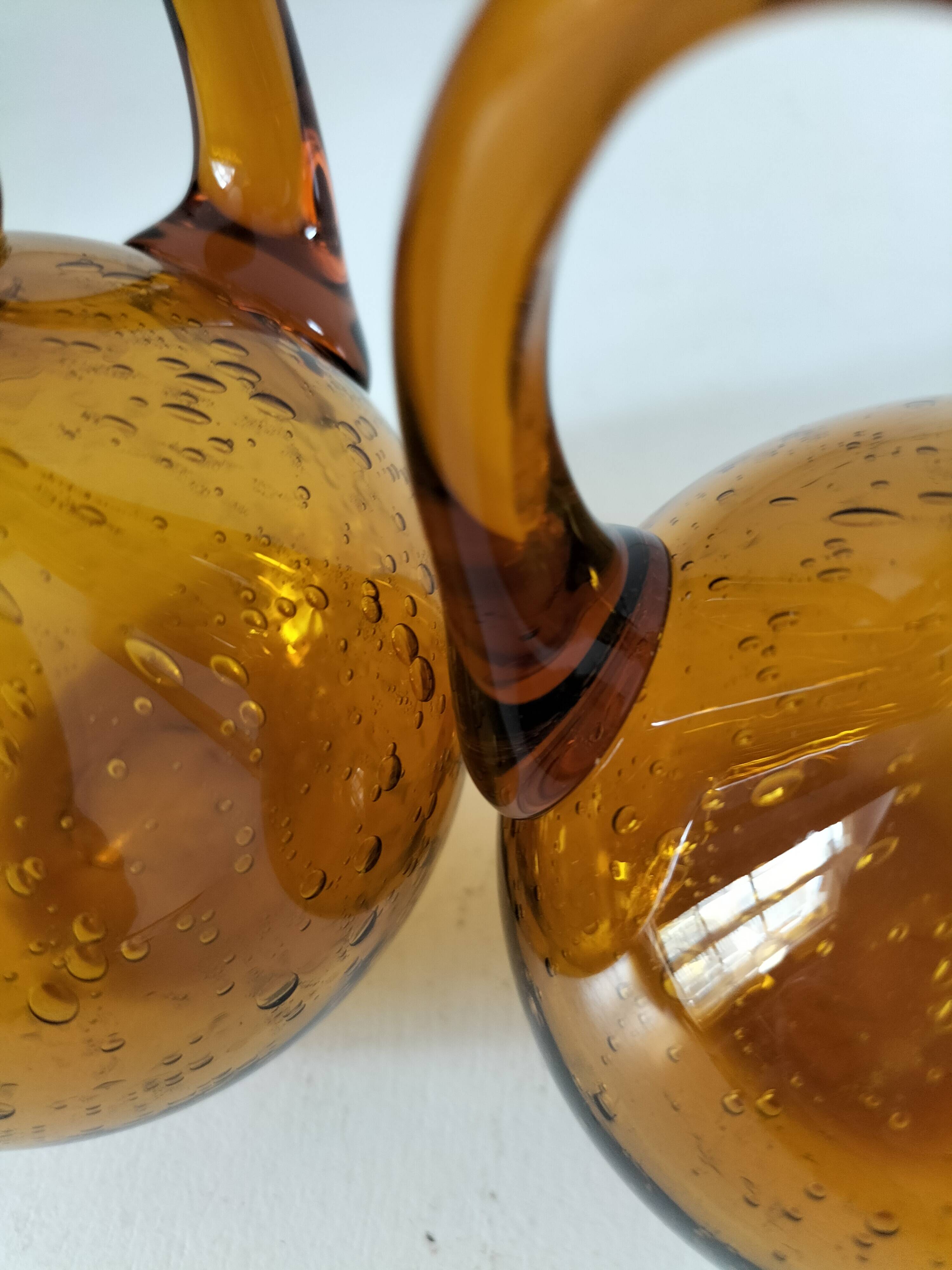 Duo of blown glass carafes – Biot signed – Bubbled amber glass