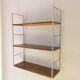 Golden wire shelf in metal with a wood effect.
