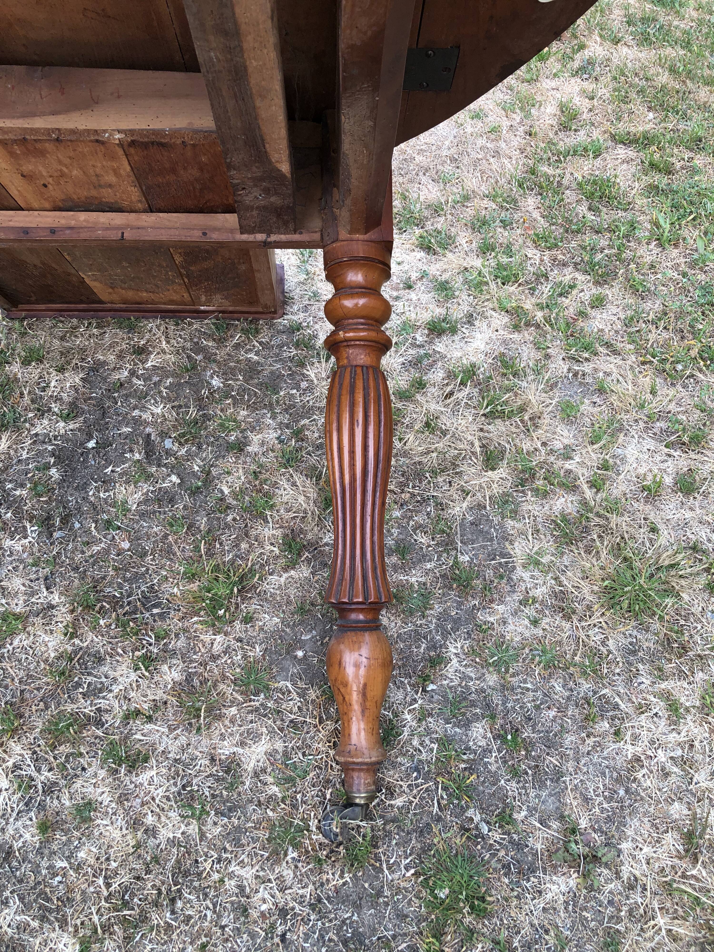 Louis Philippe oval drop-leaf table in solid cherry wood with 2 drawers.