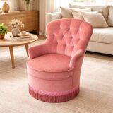 Vintage pink velvet tufted armchair with fringes.