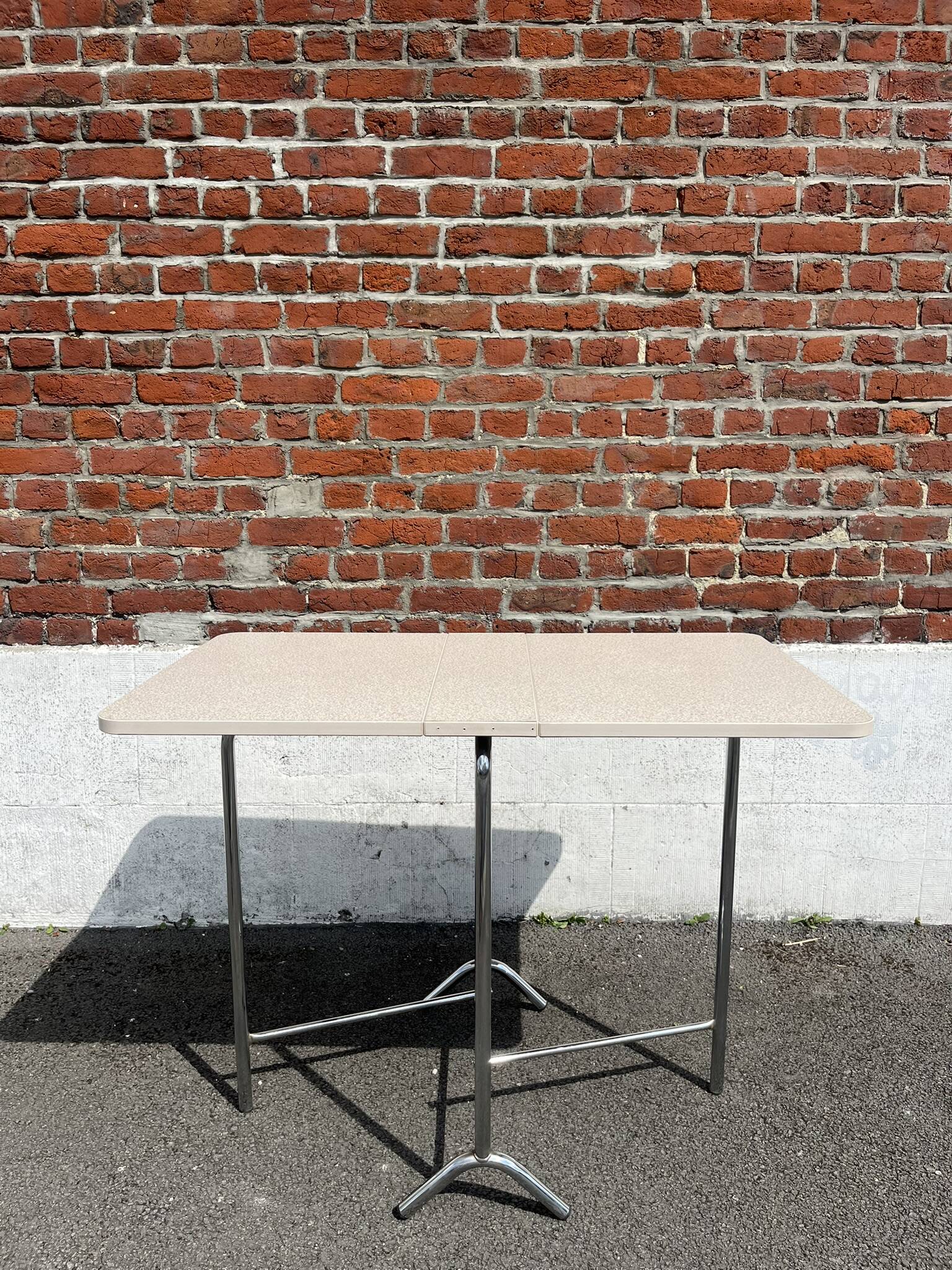 Folding table with chrome and pink formica.