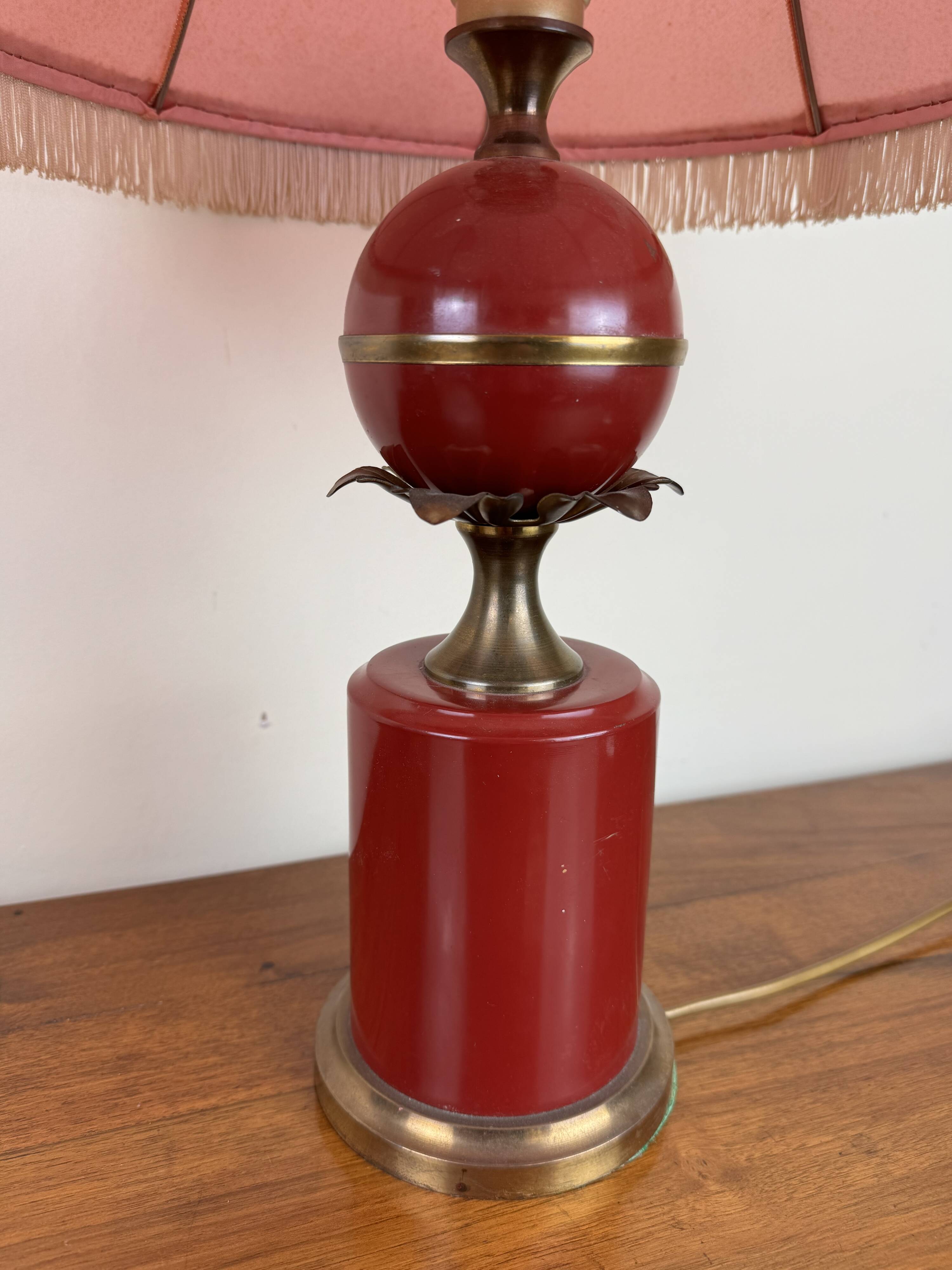 Art deco style desk lamp with a burgundy red sphere in the center the body is in lacquered iron