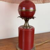 Art deco style desk lamp with a burgundy red sphere in the center the body is in lacquered iron