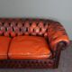 Chesterfield sofa in patinated orange leather, 2.5 seats