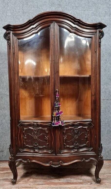 Curved library with two walnut doors, in Louis XV style.