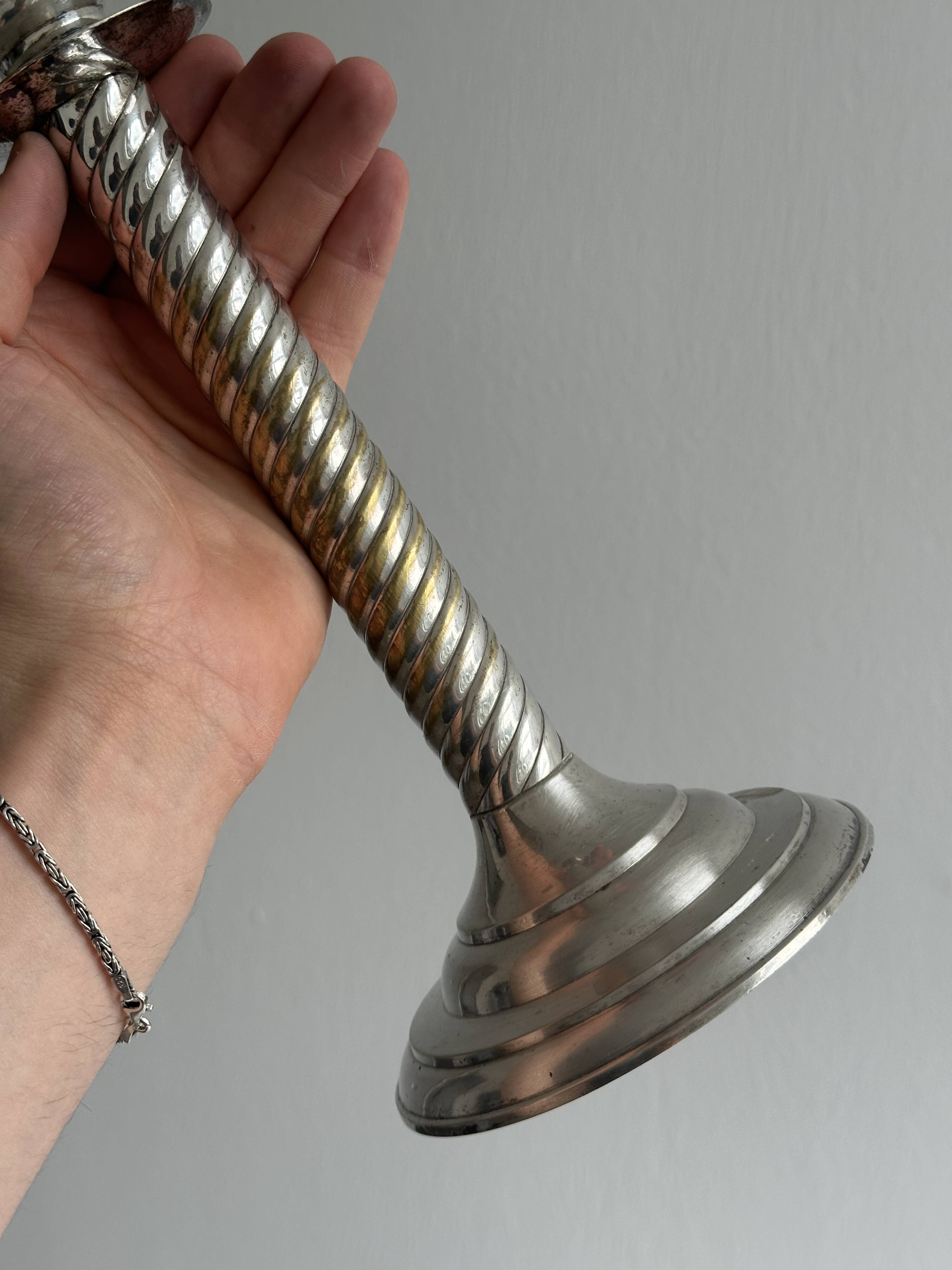 Patinated silver-plated metal candlesticks