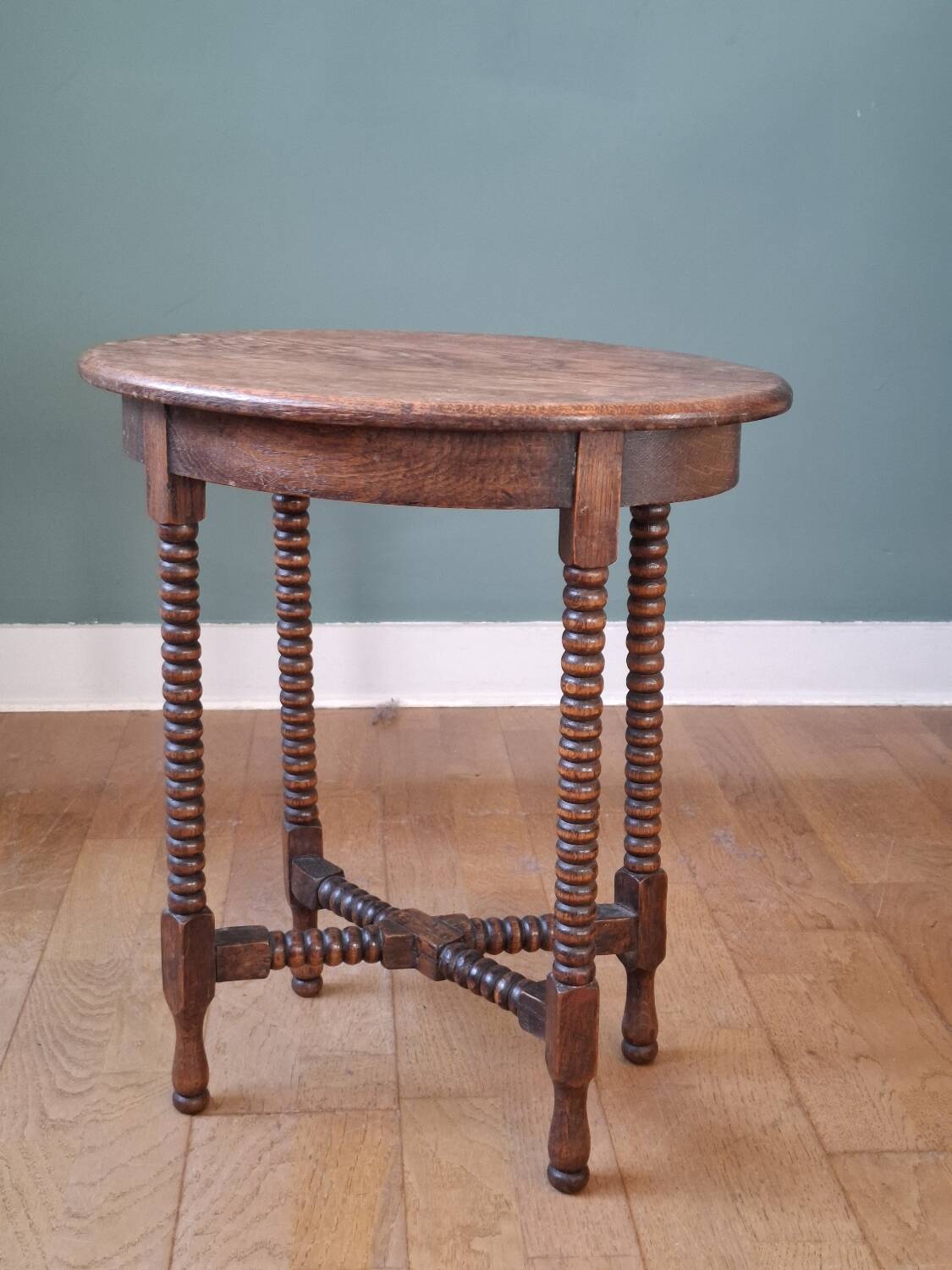Candle holder side table with spool legs